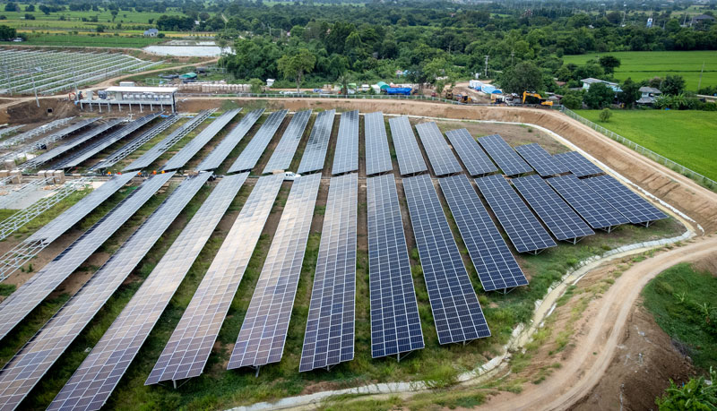 Aerial view over a modern solar farm. Solar panels station for collect green energy on concept of global ecosystem.